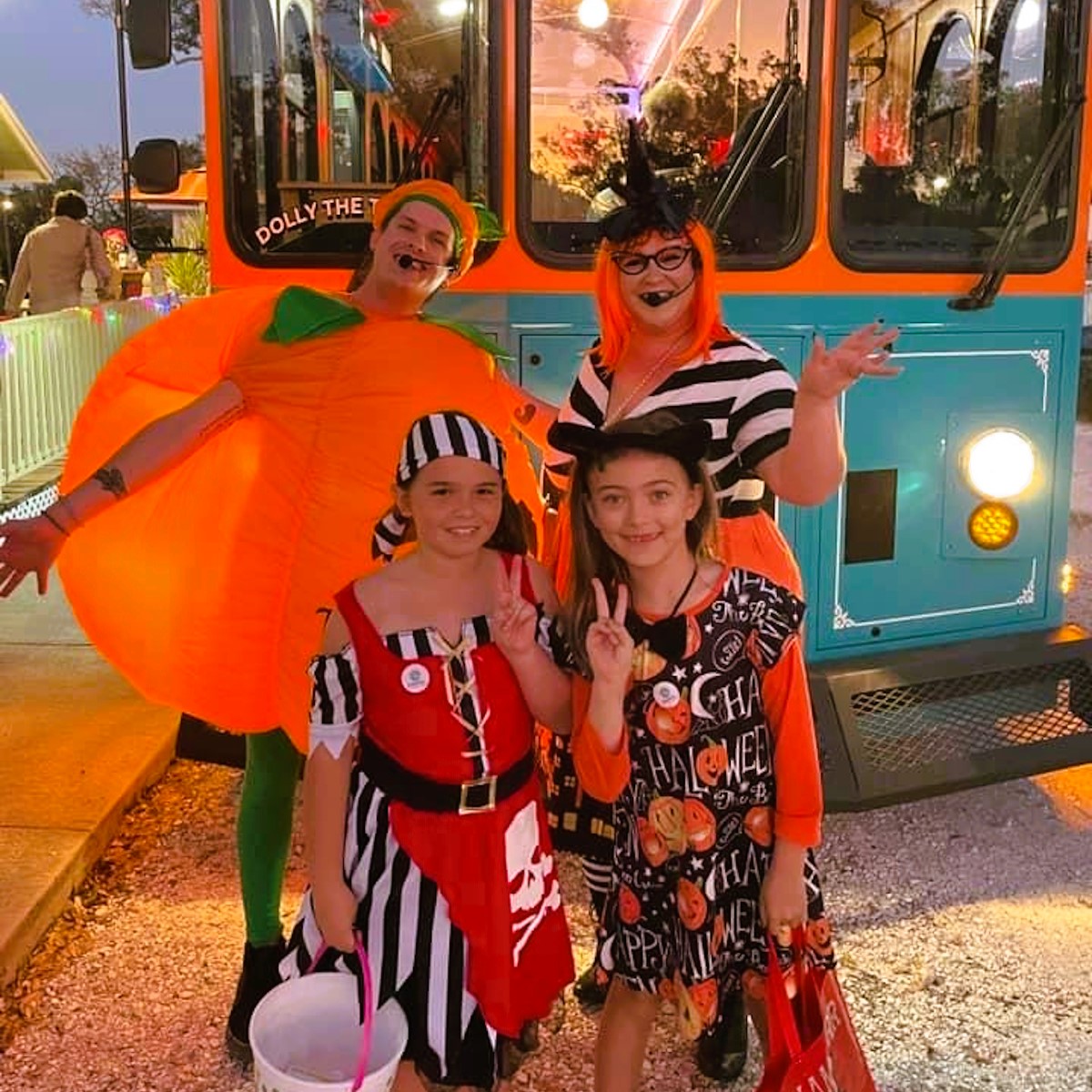 a group of people standing in front of a bus