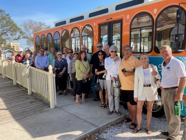 a group of people standing in front of the trolly