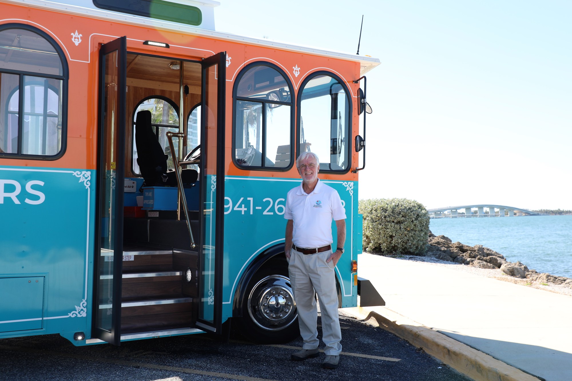 Patrick Canavan in front of trolley Pat the tour guide, standing in front of Dolly the trolley