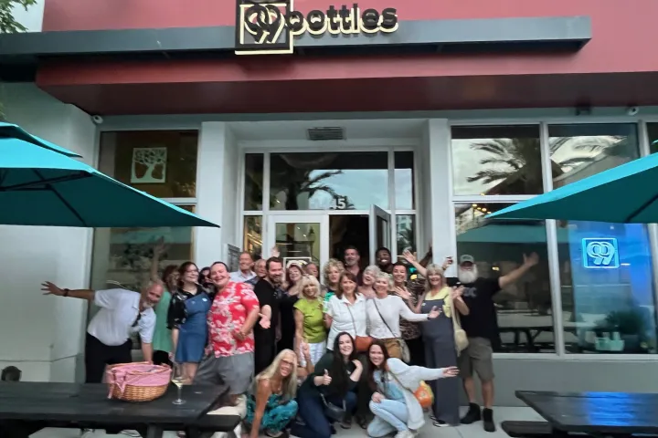 a group of people sitting in front of a store