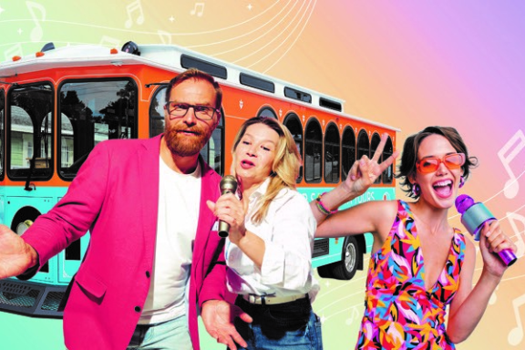 a group of people standing around a bus