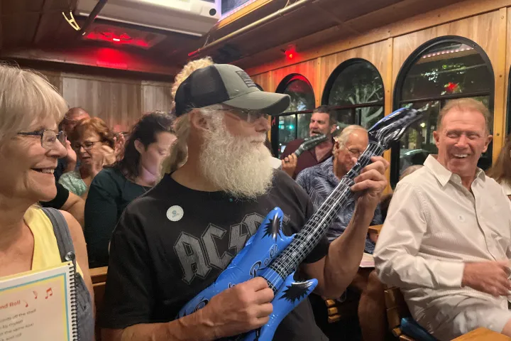 Tom Wright et al. holding wine glasses