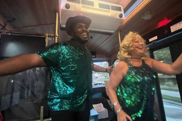 the hosts of sing-along tour on discover sarasota tours trolley singing and leading the crowd