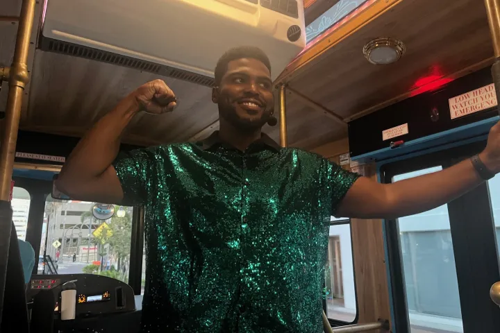 Brandon singing on the trolley