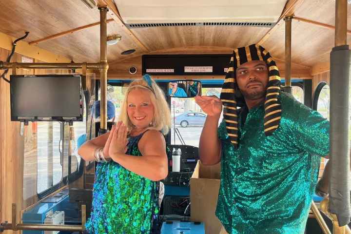 a woman standing in front of a blue wall