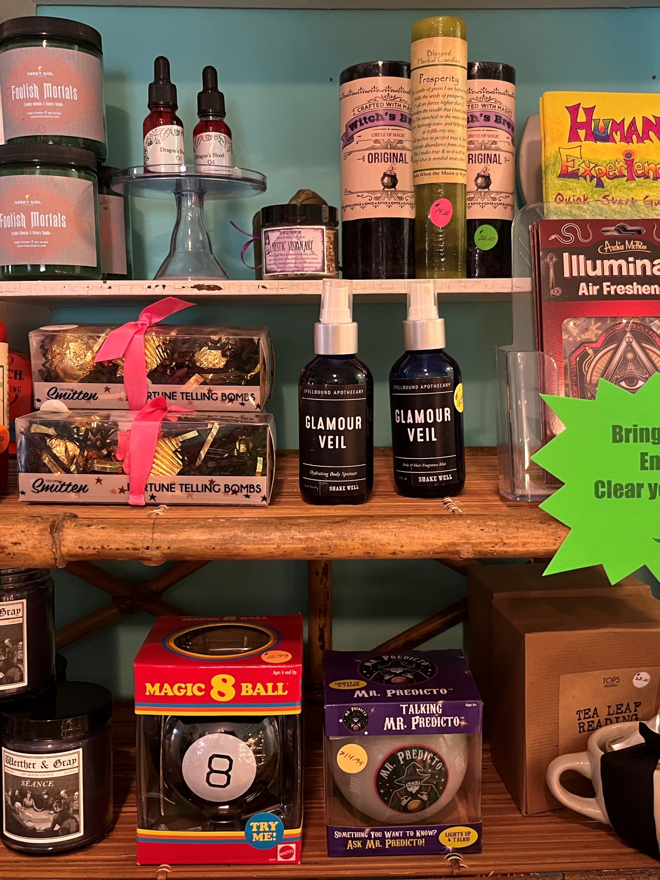 Shelf with candles, sprays, fortune bombs, and energy products.