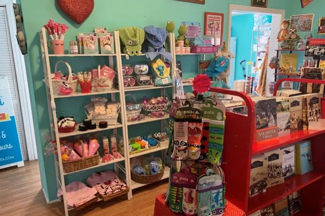 Colorful gift shop with shelves of toys, gifts, and decor on display.