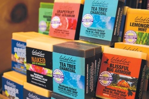 Stacks of colorful soap bars with various labels on display.