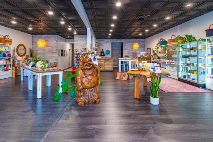 Well-lit store interior with wooden decor and assorted colorful products displayed.